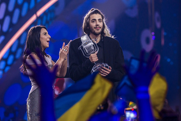 KIEV, UKRAINE - MAY 14: Salvador Sobral (R), the contestant from Portugal, receives the trophy after being announced as the winner from last year's winner Jamala at the Eurovision Grand Final on May 14, 2017 in Kiev, Ukraine. Ukraine is the 62nd host of the annual iteration of the international song contest. It is the longest running international TV song competition, held primarily among countries from Europe. Each participating country will perform an original song, votes cast by the other countries determine the winner. This year's winner Salvador Sobral from Portugal won with his love ballad 'Amar Pelos Dois'.  (Photo by Brendan Hoffman/Getty Images)